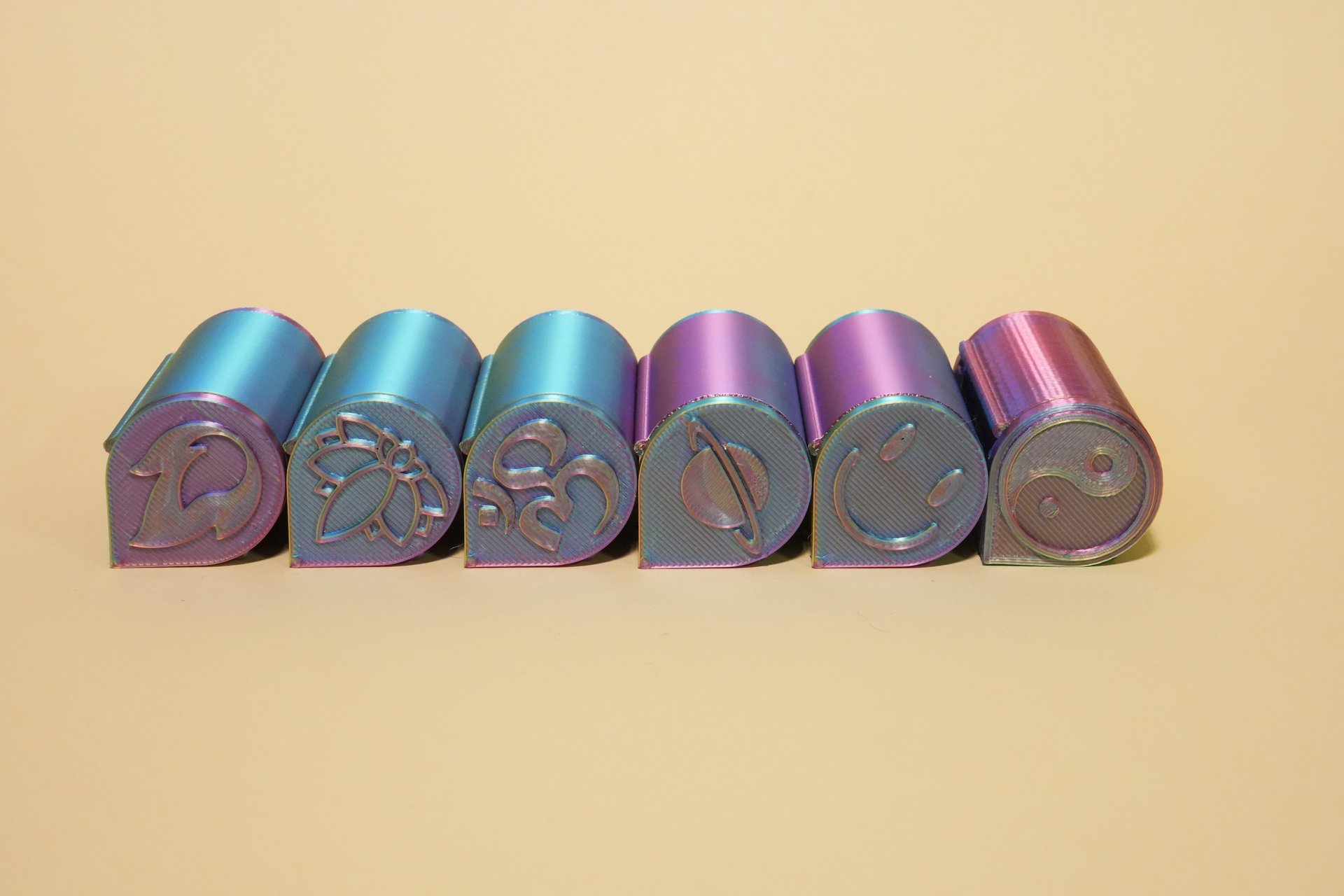 Sechs nibli™ Multicolor-Spender in Lila, Blau, Rot und Gelb auf cremefarbenem Hintergrund